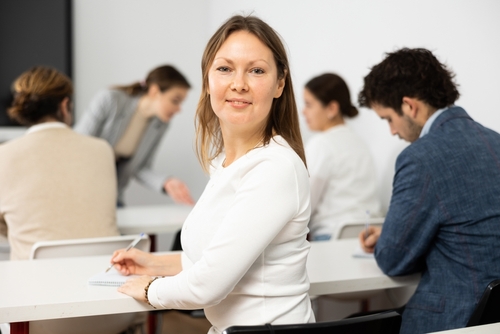 Portrait of Successful Business Woman Smiling At Camera During Symposium